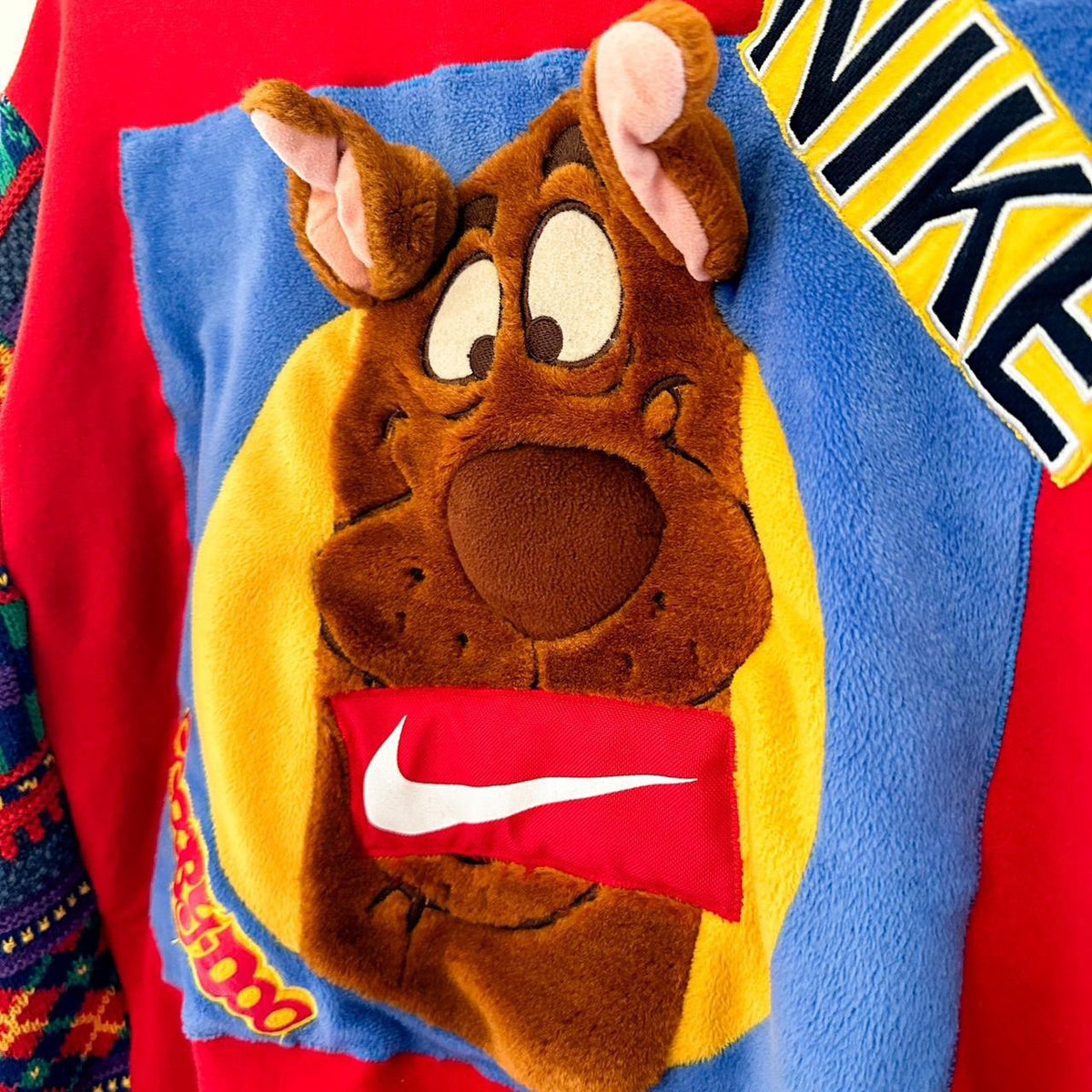 A nike sweatshirt with a scooby doo face on it.