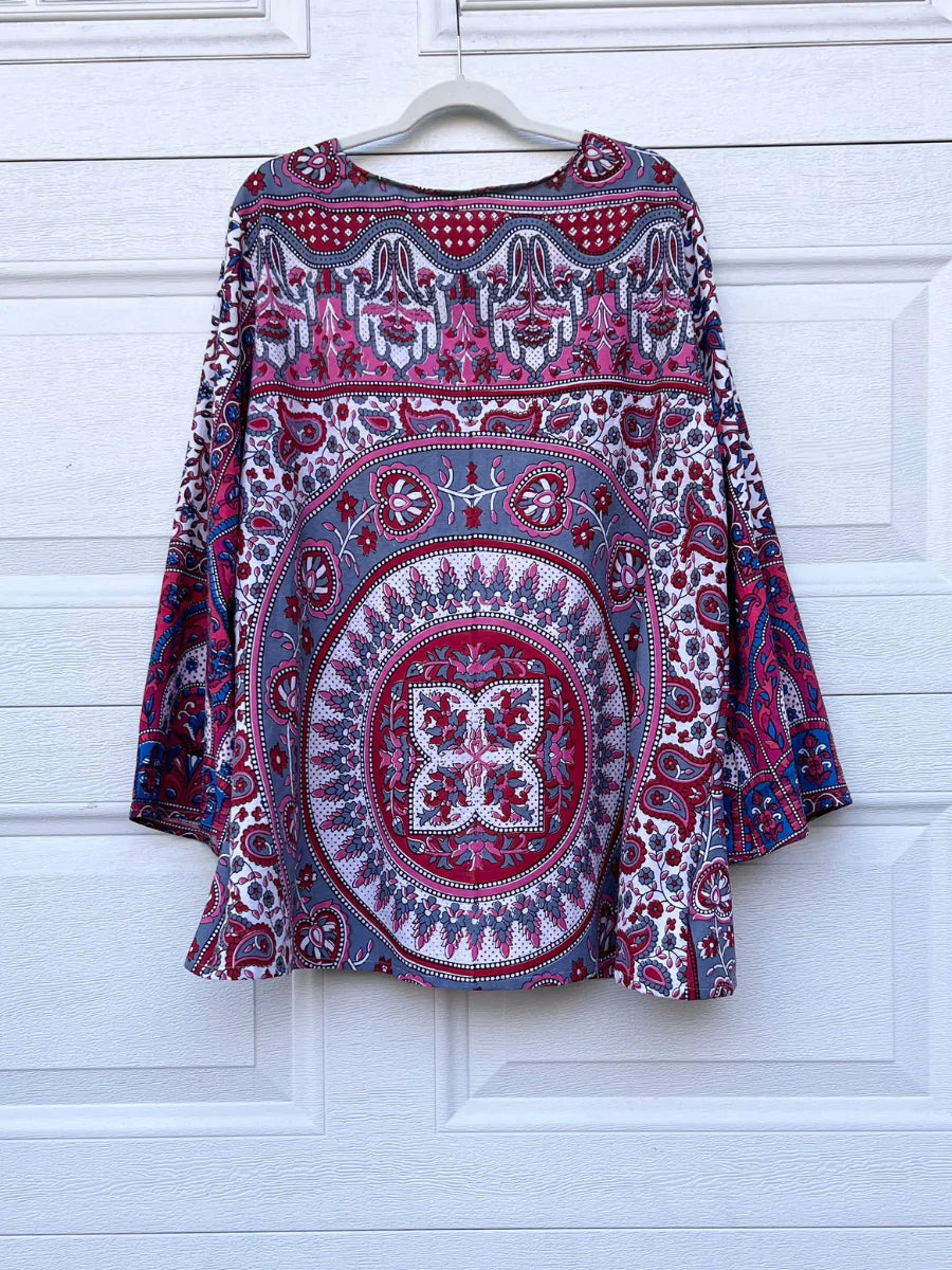a red and blue shirt hanging on a white door.