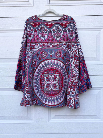 a red and blue shirt hanging on a white door.