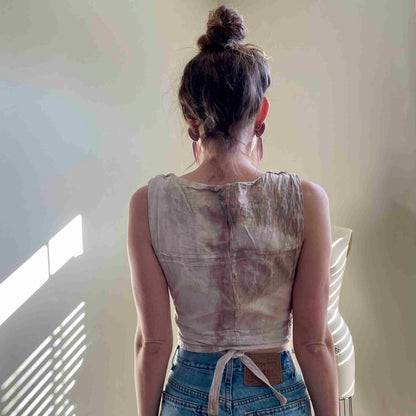 a woman standing in front of a window with her back to the camera.