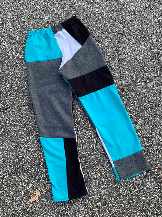 a pair of blue and black pants laying on the ground.