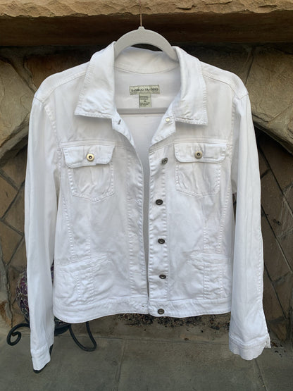Mick Jagger Swagger White Denim Jacket hanging on a stone wall.