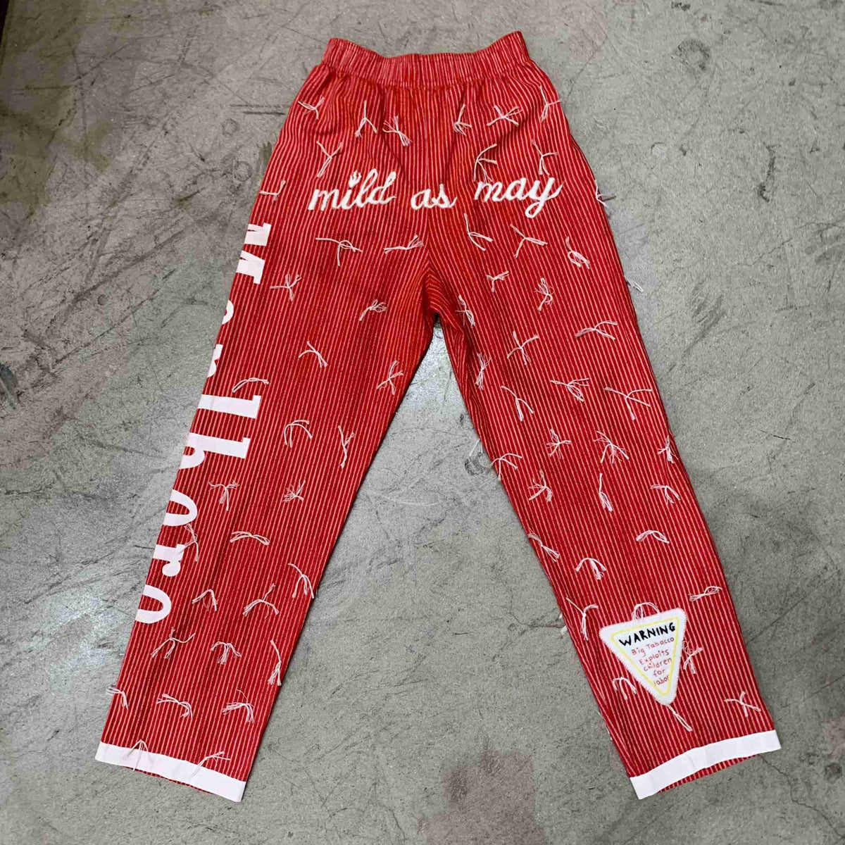 a pair of red pants with white writing on them.