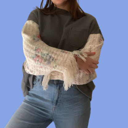 A woman wearing jeans and a sweater.