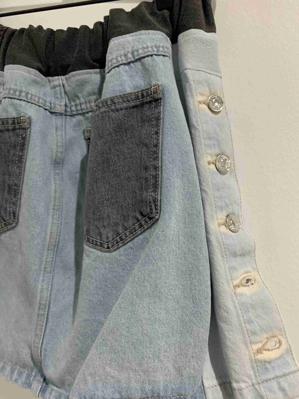 a pair of jeans hanging on a clothes rack.