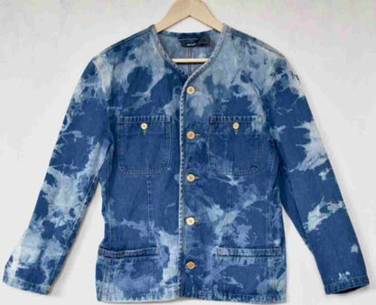 a blue jean jacket hanging on a hanger.