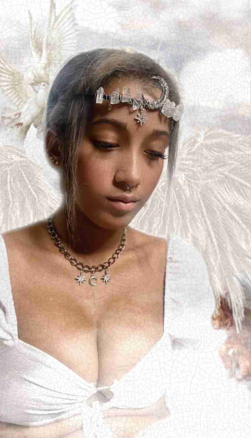 a woman in a white dress with angel wings.