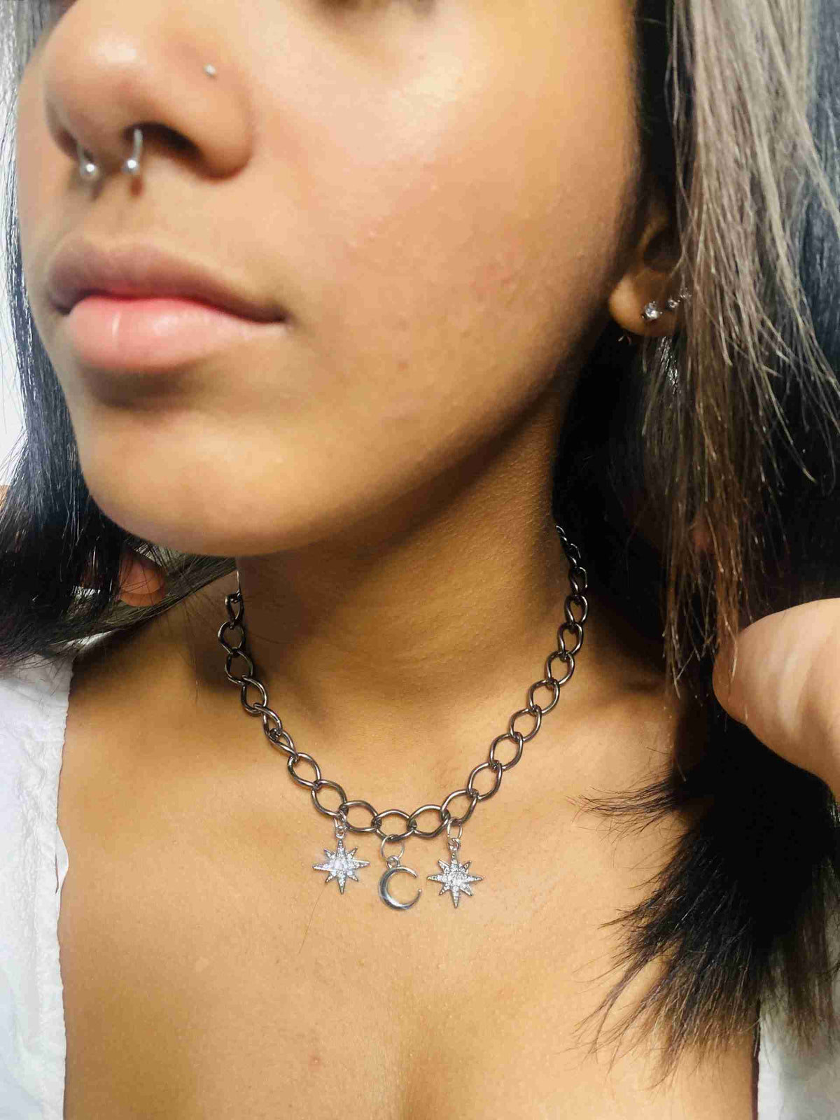 a close up of a person wearing a necklace.