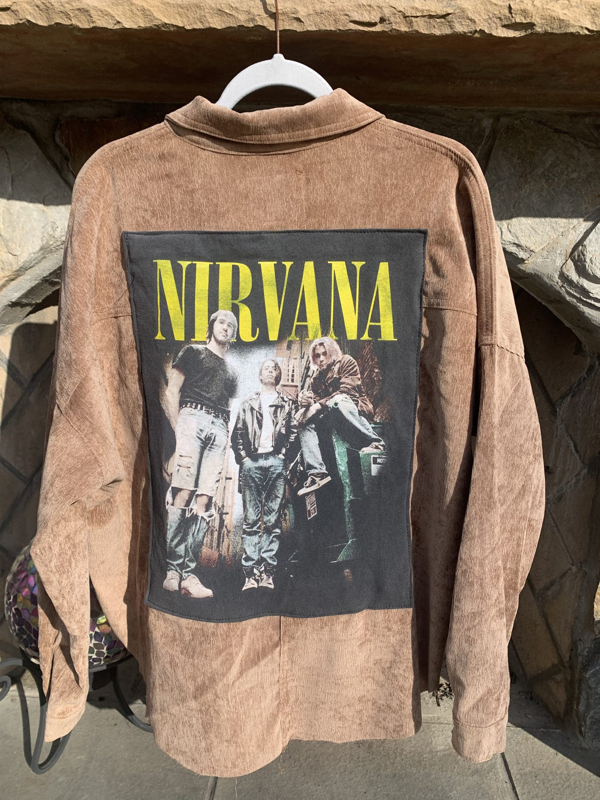 A Nirvana Corduroy Jacket with a picture of Nirvana on it.