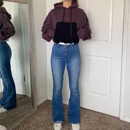 A woman standing in front of a mirror.