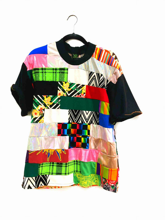 a multicolored shirt hanging on a hanger.