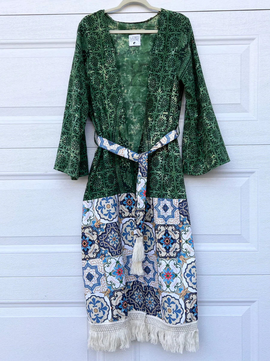 a green dress hanging on a white door.