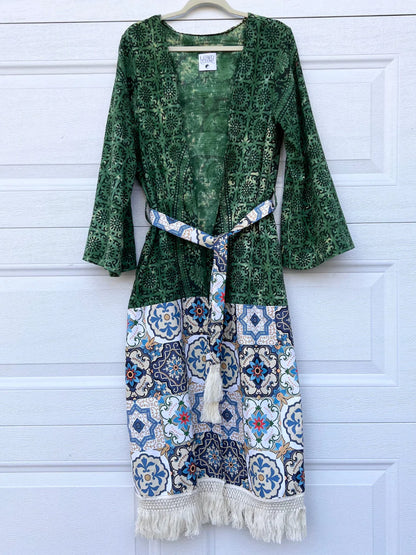 a green dress hanging on a white door.