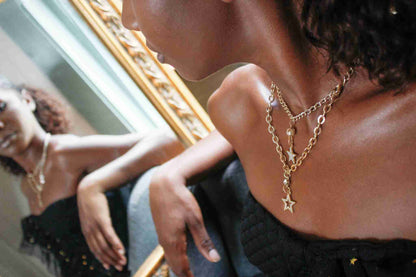 a woman looking at herself in a mirror.