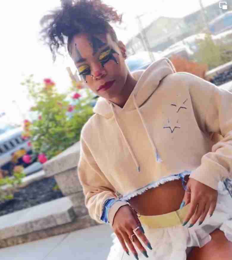 a woman in a white hoodie and white skirt.