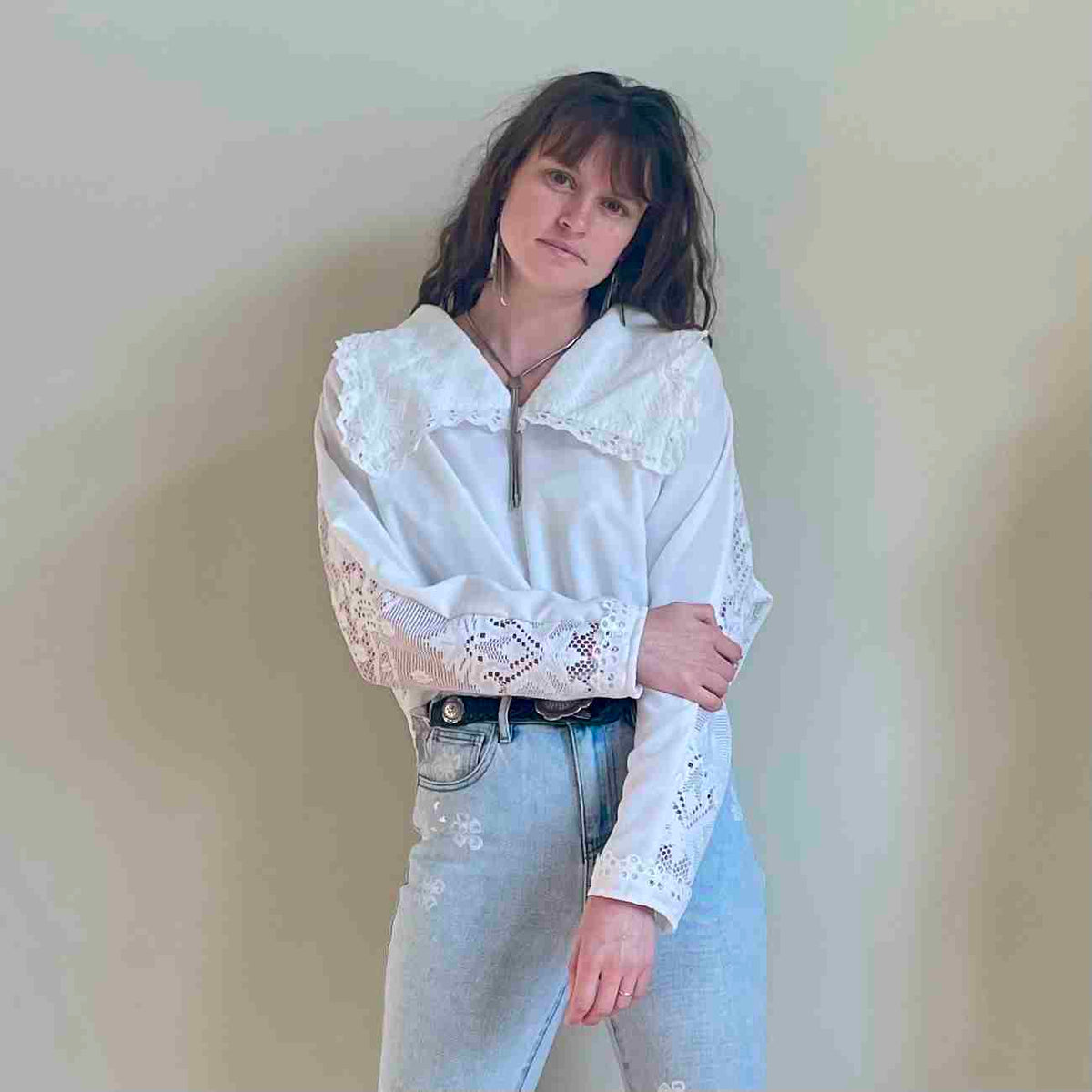a woman wearing a white shirt and jeans.