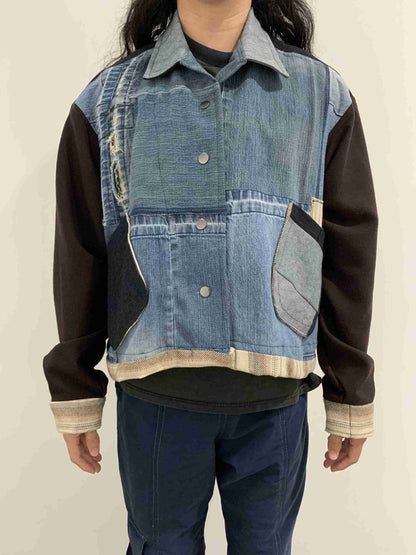 a person wearing a jean jacket with a patch on the back.