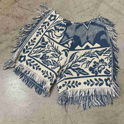 a blue and white blanket laying on a floor.