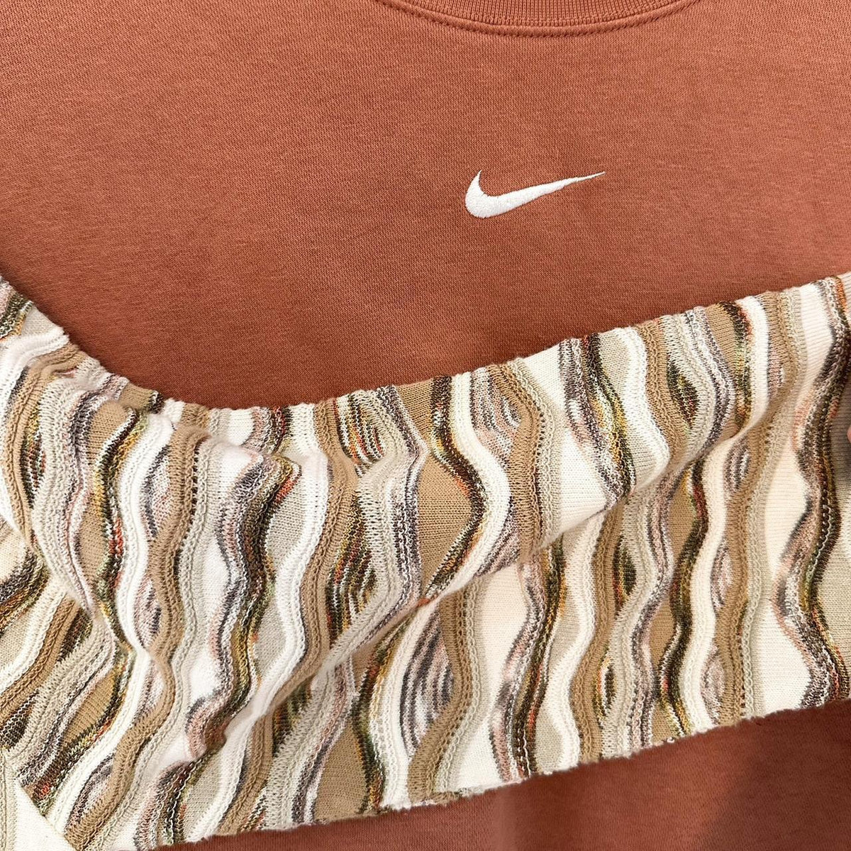 A nike sweatshirt with a striped pattern on it.