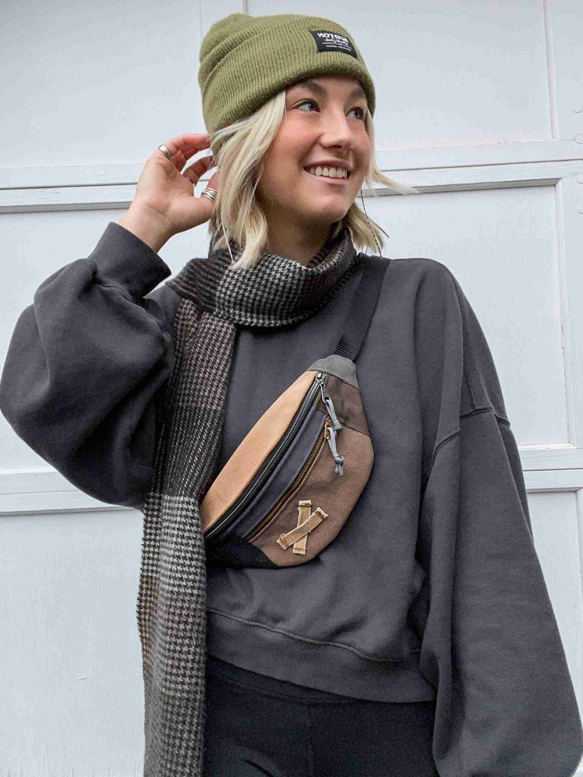 a woman wearing a green hat and scarf.
