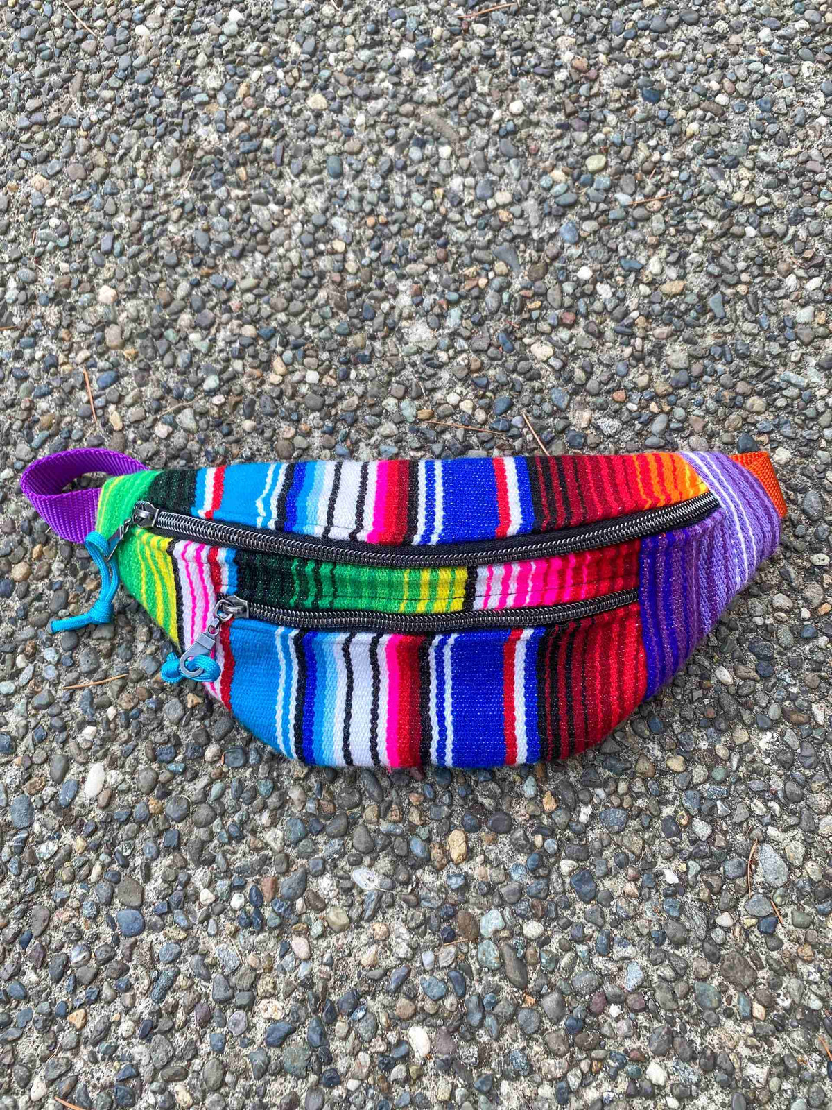 a multicolored striped purse with a zipper.