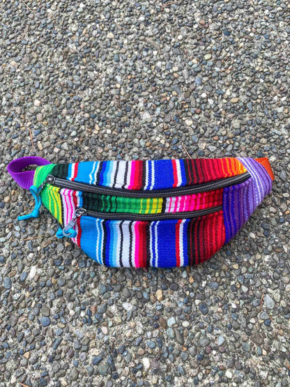 a multicolored striped purse with a zipper.