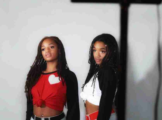 two young women standing next to each other.