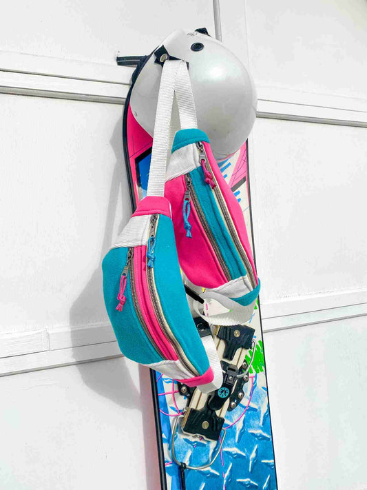 a snowboard hanging from a hook on a wall.