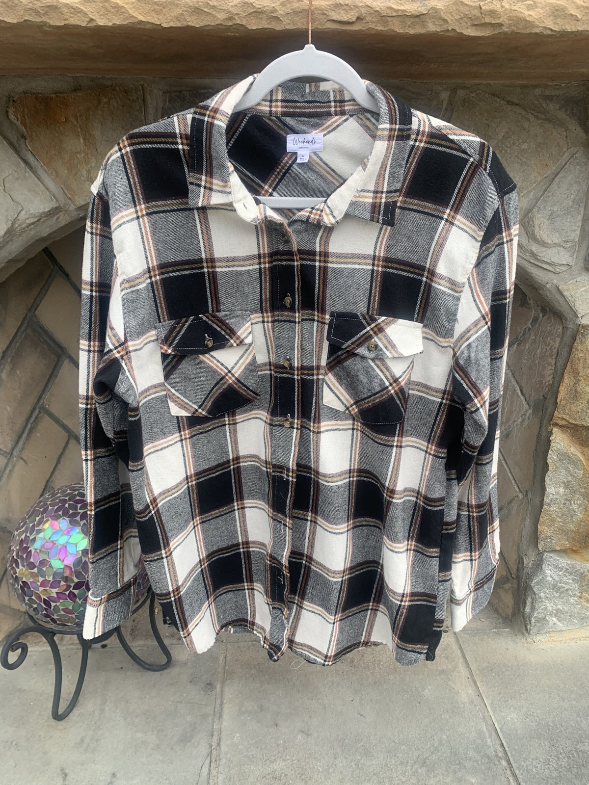 A Green Day flannel shirt hanging on a rack.
