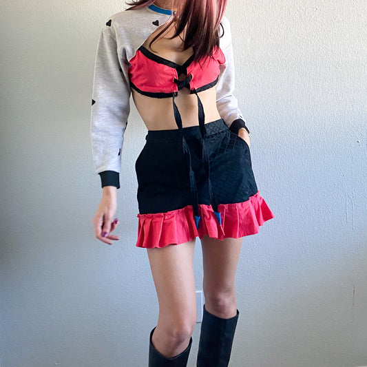 A woman in a skirt and boots.