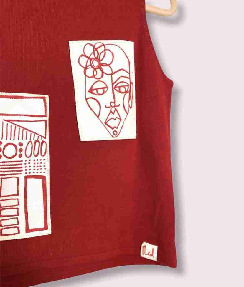 a drawing of a woman's face on a red shirt.