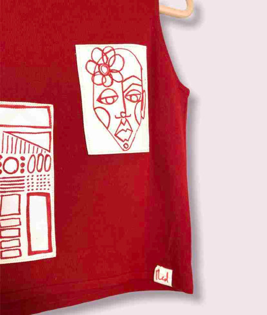 a drawing of a woman's face on a red shirt.