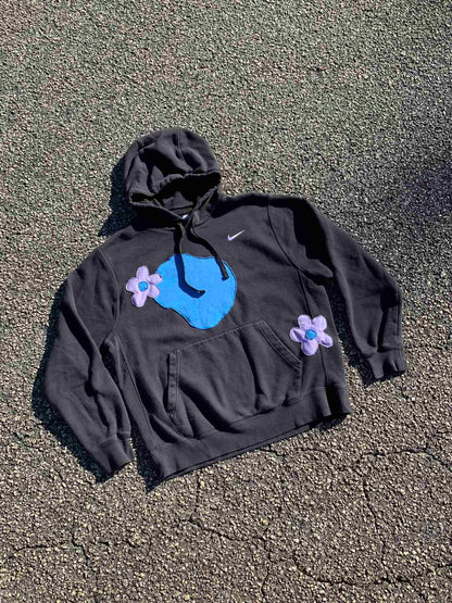 a black hoodie with a blue face on it.