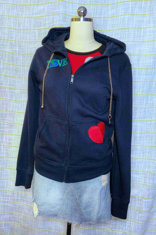 a blue hoodie with a heart patch on it.