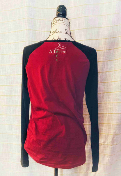 a red and black top on a mannequin.
