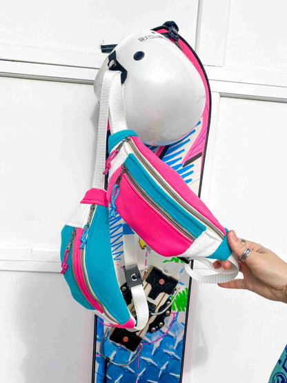 a person is holding a skateboard and a bag.