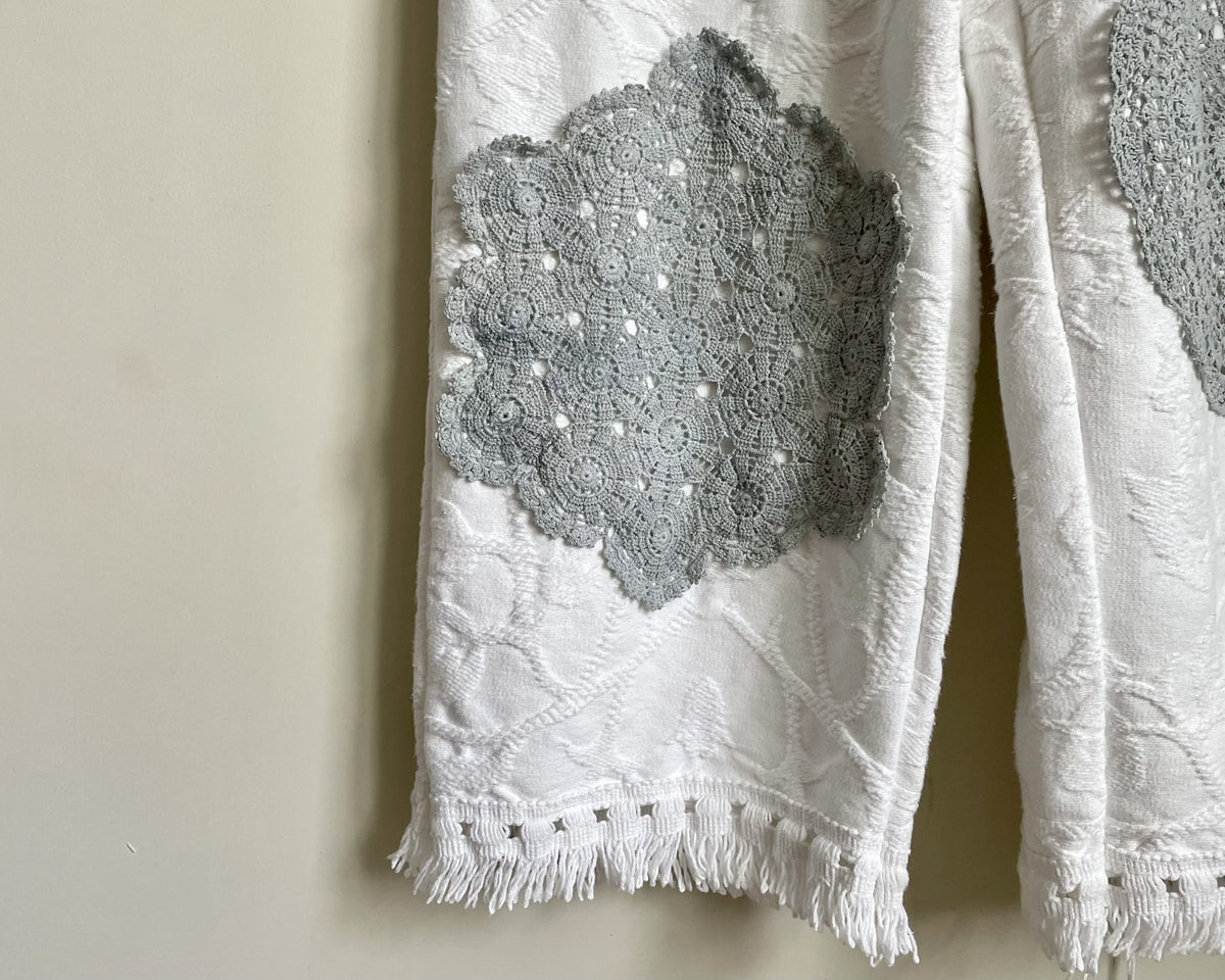 a pair of white pants hanging on a wall.