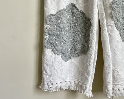 a pair of white pants hanging on a wall.