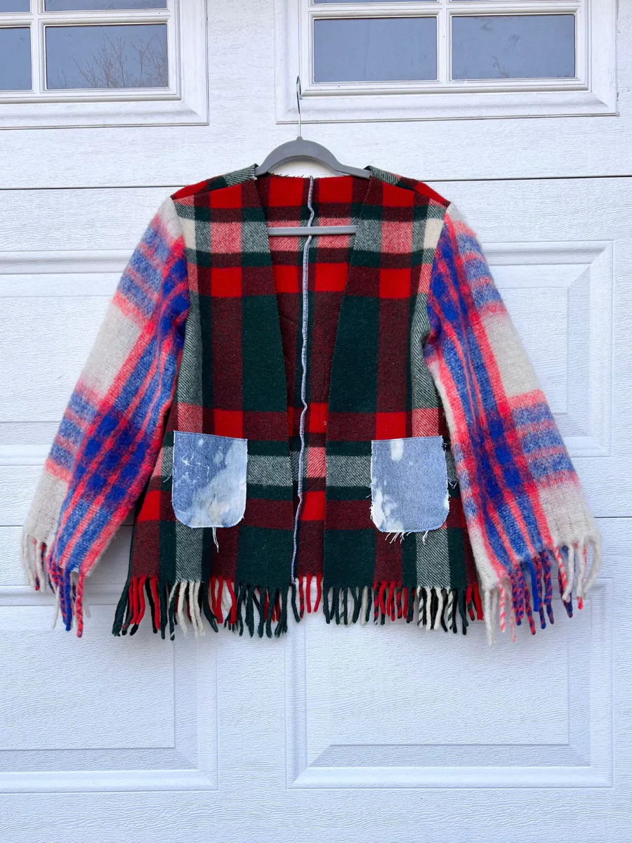 a plaid jacket hanging on a garage door.