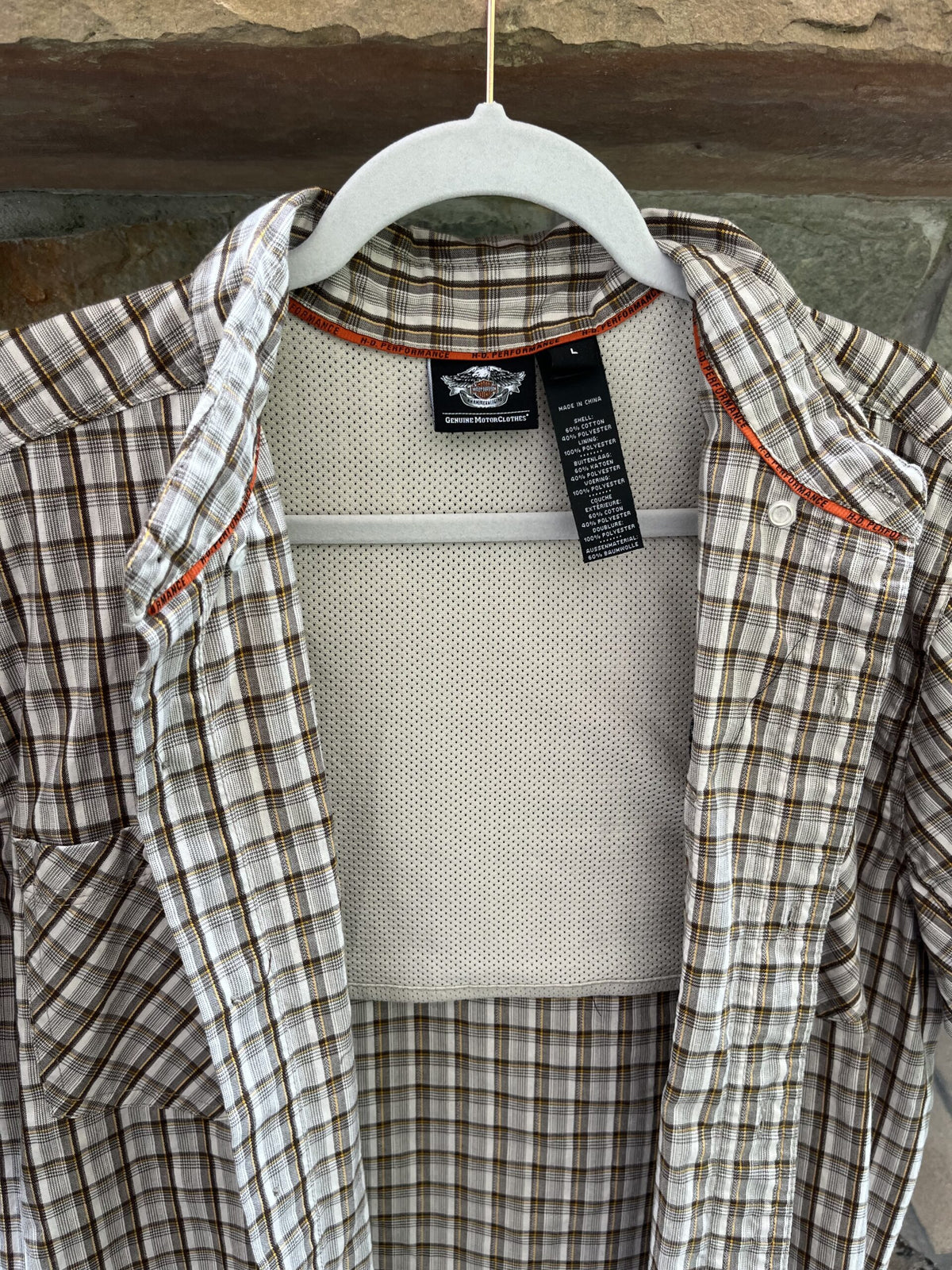 a button up shirt hanging on a clothes hanger.