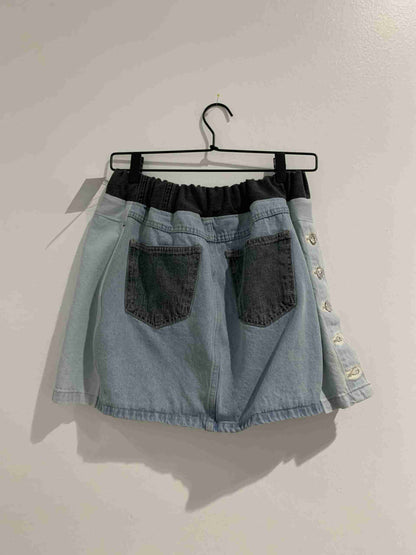 a denim skirt hanging on a hanger.