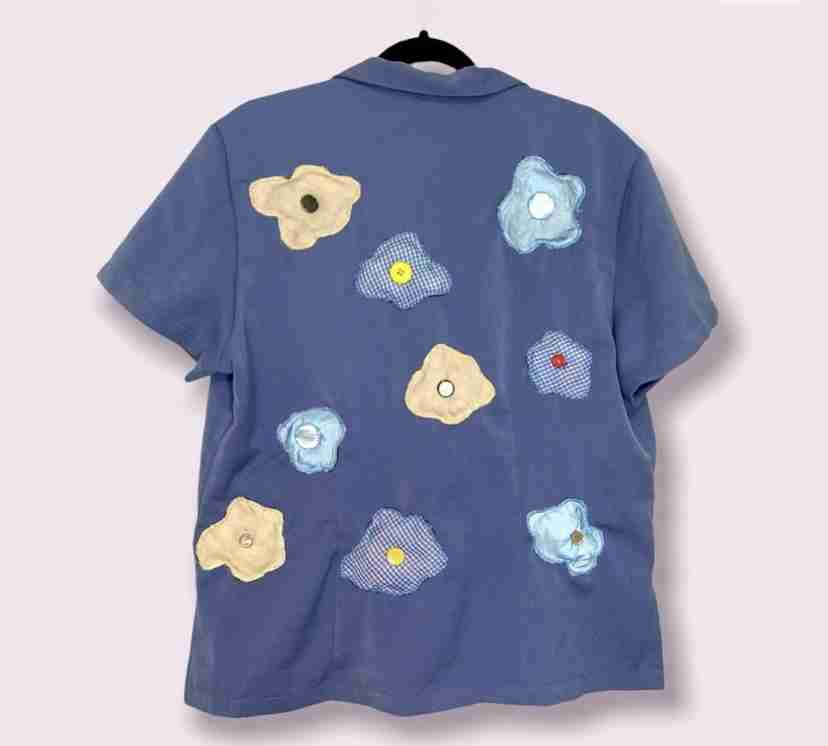 a blue shirt with flowers on it.