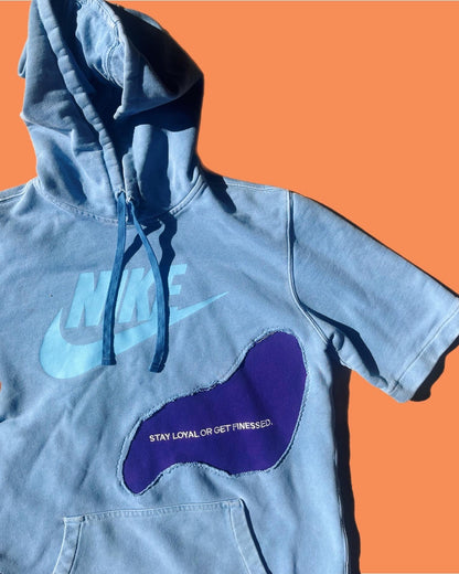 a blue hoodie with a purple shoe on it.