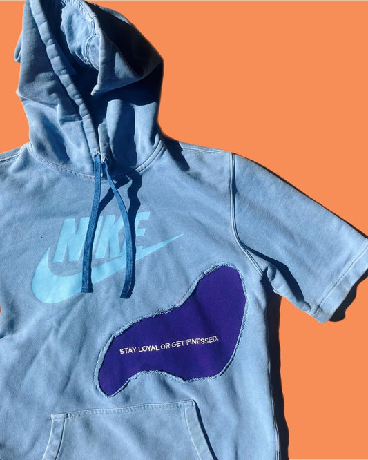a blue hoodie with a purple shoe on it.