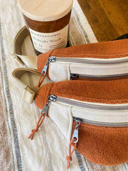 a pair of zippered purses sitting on top of a table.