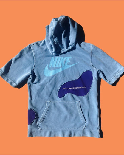 a blue nike hoodie on an orange background.