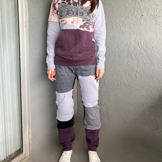 A woman wearing a purple hoodie and sweatpants.