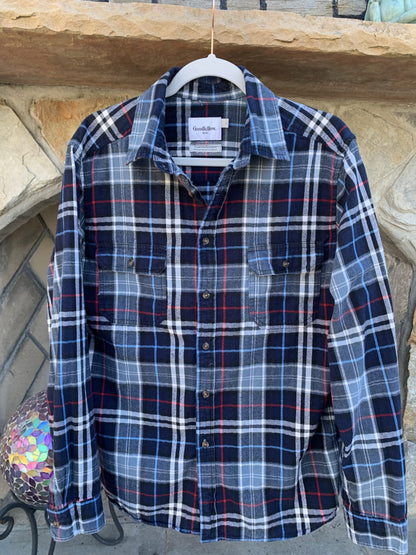 A Motley Crue Flannel Long Sleeve Shirt hanging on a clothes rack.
