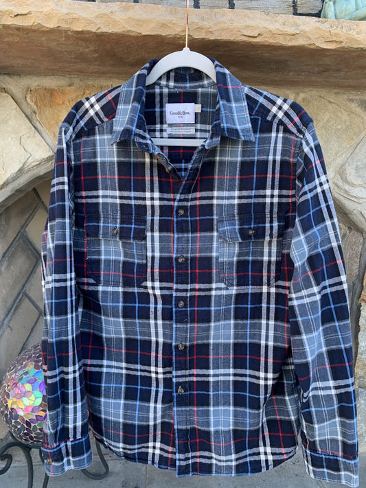 A Motley Crue Flannel Long Sleeve Shirt hanging on a clothes rack.