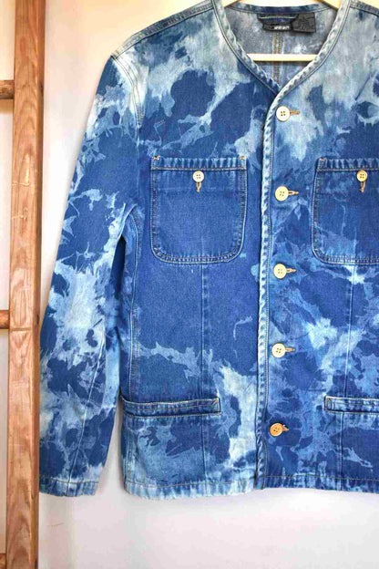 a blue jean jacket hanging on a wall.